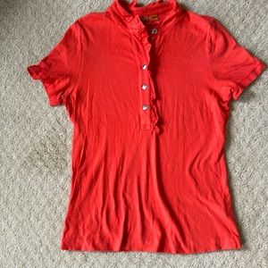 Tory Burch top size M actually a L but runs small.  (Auburn orange)